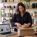 Melbourne retailer packing an online order beside a laptop showing an e-commerce product page